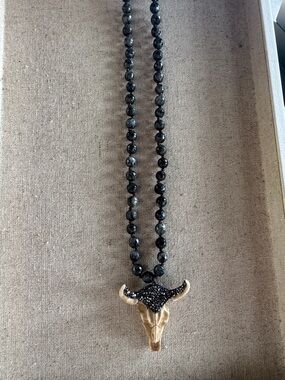 Beaded Necklace with Horned Skull Pendant in Black and Natural tone.